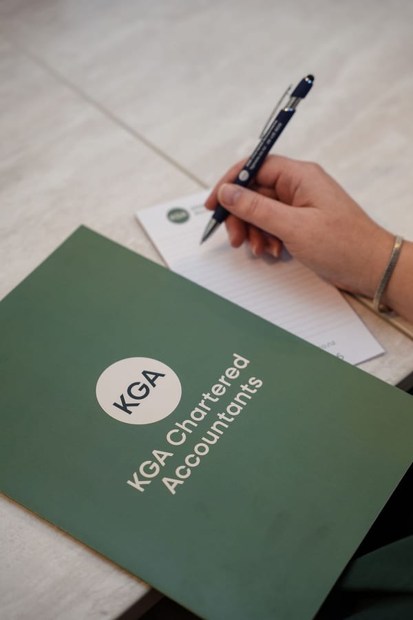 KGA Chartered Accountants folder beside handwritten working notes